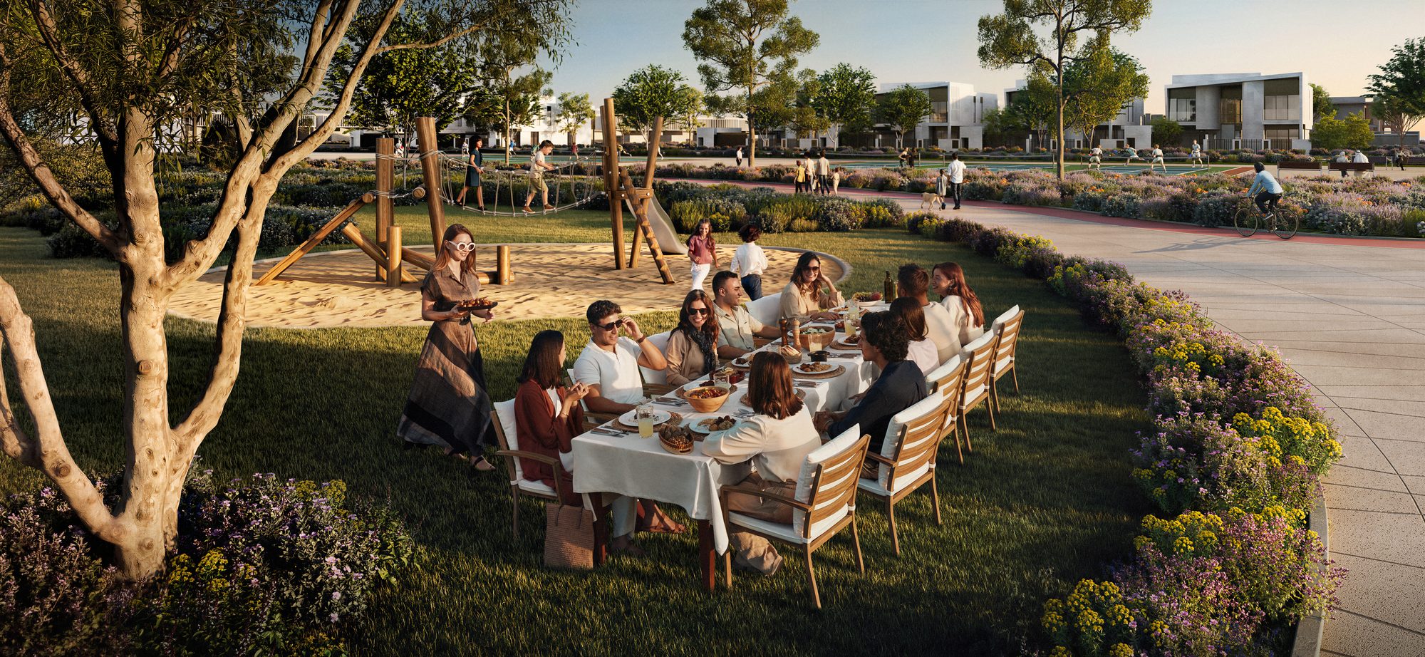 Community centre lawn with family dining at Marsa Al Saadiyat — Aldar key visual